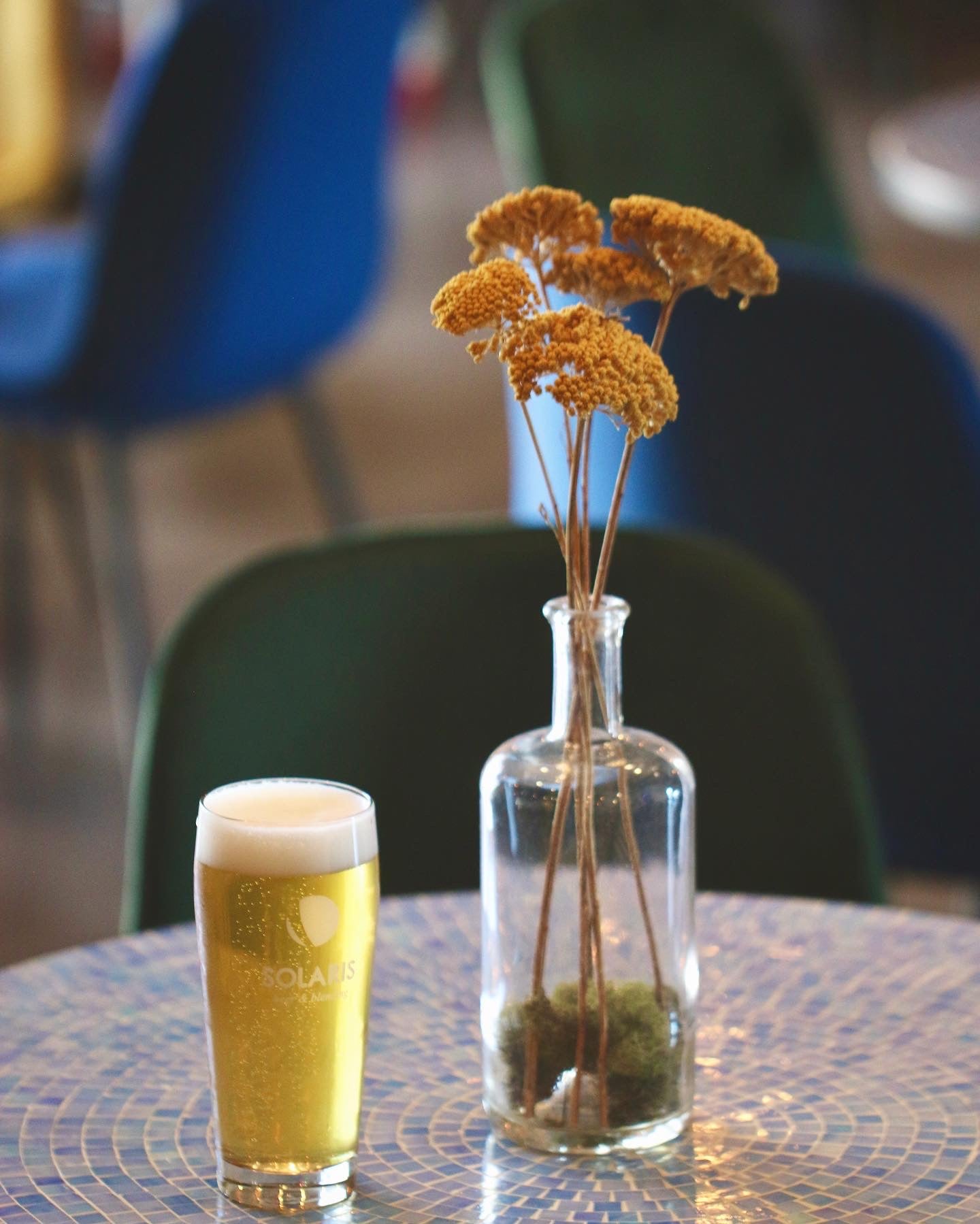 West Coast IPA on a table with flowers in Murrieta Taproom.